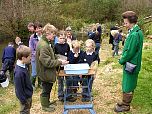 Children from a local school show the pond life they have found to The Princess Royal.