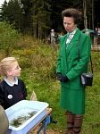 Children from a local school show the pond life they have found to The Princess Royal.