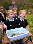 Children from a local school show the pond life they have found to The Princess Royal.