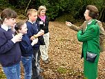 Local school children and Group Leader Sue Searle discuss how they are studying the wildlife in the woodland leaf litter.