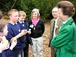 Local school children and Group Leader Sue Searle discuss how they are studying the wildlife in the woodland leaf litter.