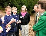 Local school children and Group Leader Sue Searle discuss how they are studying the wildlife in the woodland leaf litter.