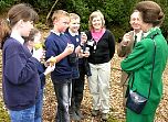 Local school children and Group Leader Sue Searle discuss how they are studying the wildlife in the woodland leaf litter.