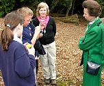 Local school children and Group Leader Sue Searle discuss how they are studying the wildlife in the woodland leaf litter.